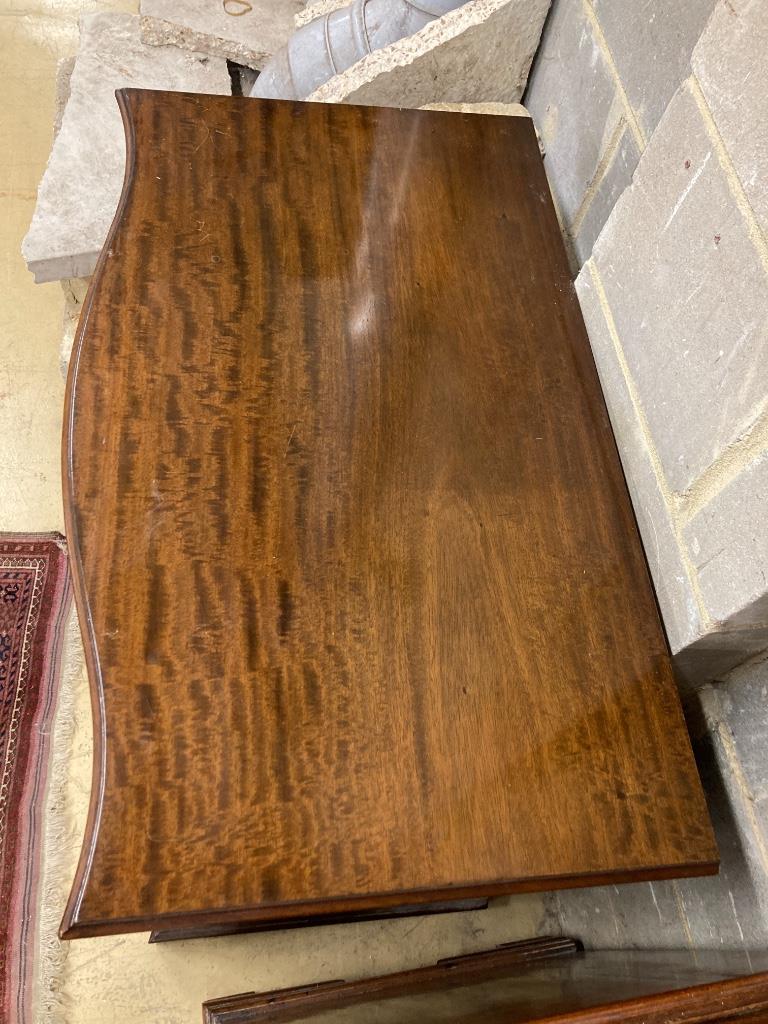 A George III style mahogany serpentine chest